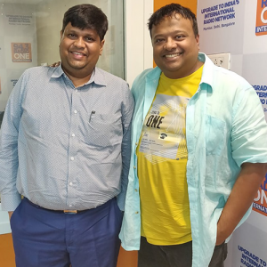 Two men standing together in a radio studio